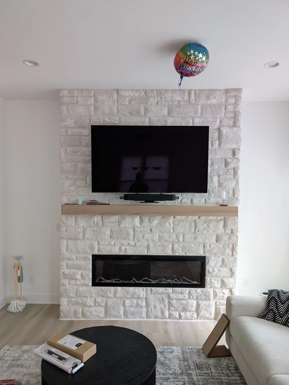 White stone modern fireplace with TV