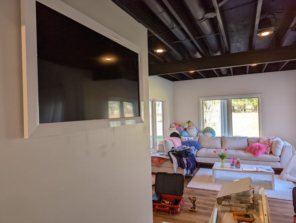 Samsung Frame TV installed by Rock Paper TV with all components concealed in a media enclosure, achieving a clean and stylish look. TV Mounting Louisville Kentucky